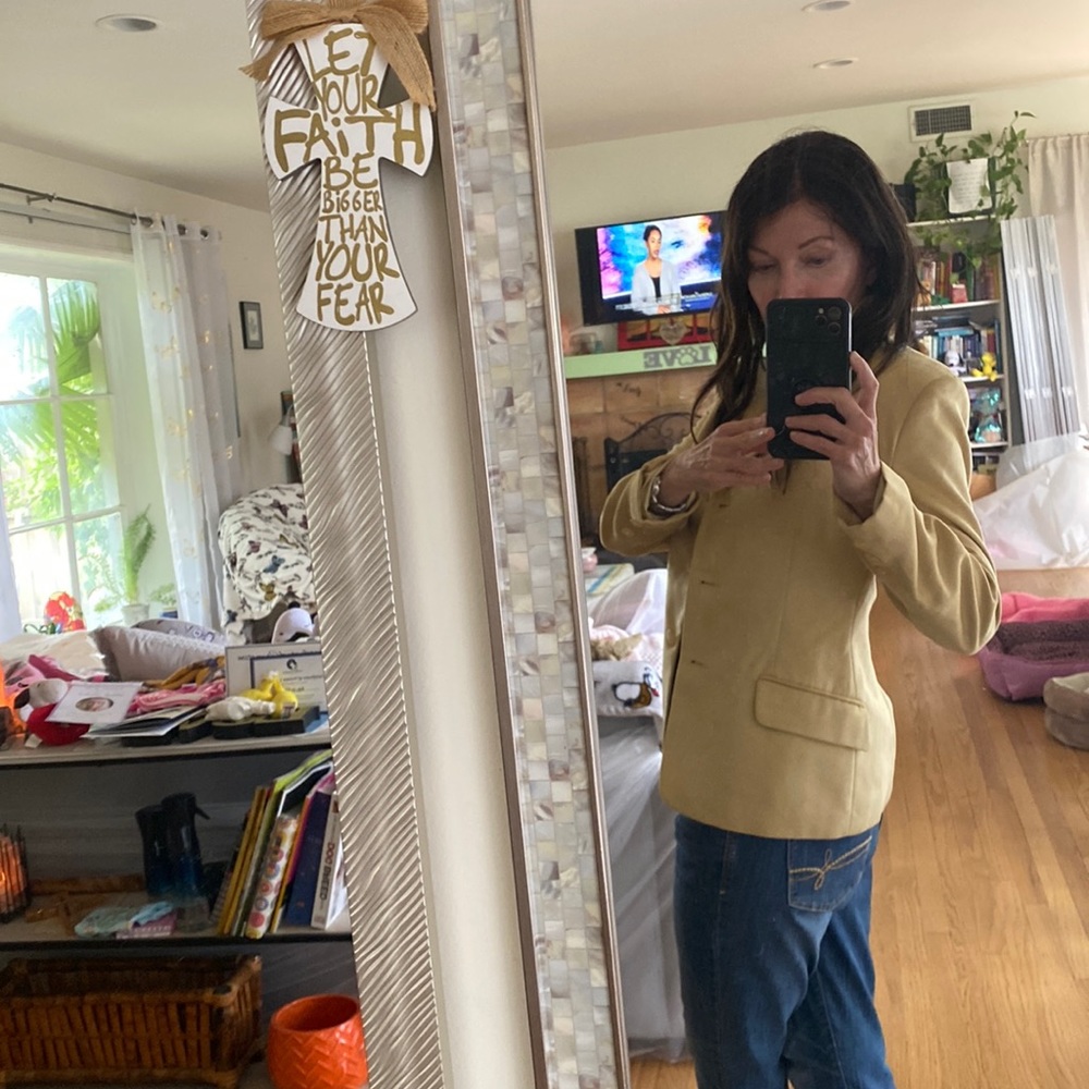 Feels like suede, it’s a very pretty soft jacket and skirt.  Made in Canada.